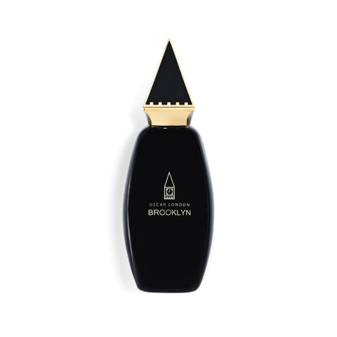 Elegant Oscar London Brooklyn perfume bottle from the Big Ben Collection. The sleek black bottle features a distinctive gold triangular cap, inspired by the architectural elements of Big Ben. The minimalist gold-engraved branding adds a touch of sophistication, making this fragrance a statement of luxury and style