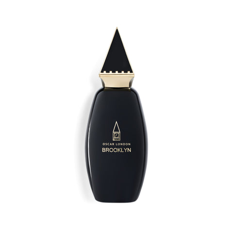 Elegant Oscar London Brooklyn perfume bottle from the Big Ben Collection. The sleek black bottle features a distinctive gold triangular cap, inspired by the architectural elements of Big Ben. The minimalist gold-engraved branding adds a touch of sophistication, making this fragrance a statement of luxury and style